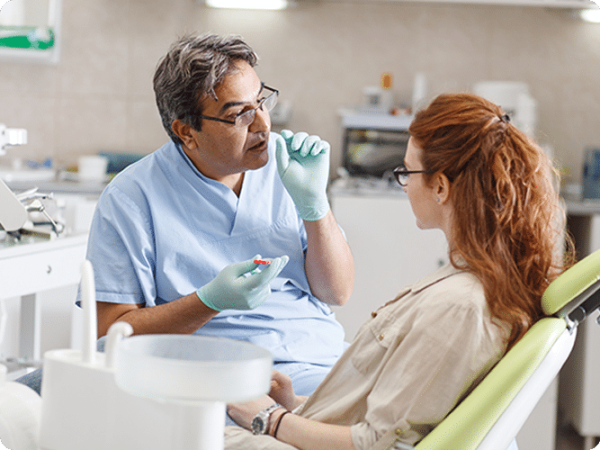 One of our dental professionals discussing treatment plan with patient in examination room