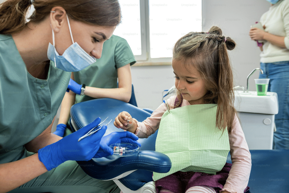 One of our dental professionals examining a young patient's teeth during a routine checkup