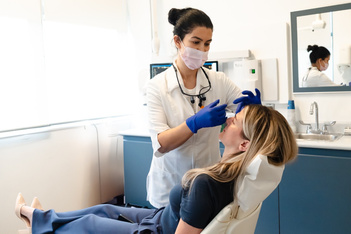 One of our dental professionals examining a patient's teeth at our clinic treatment room