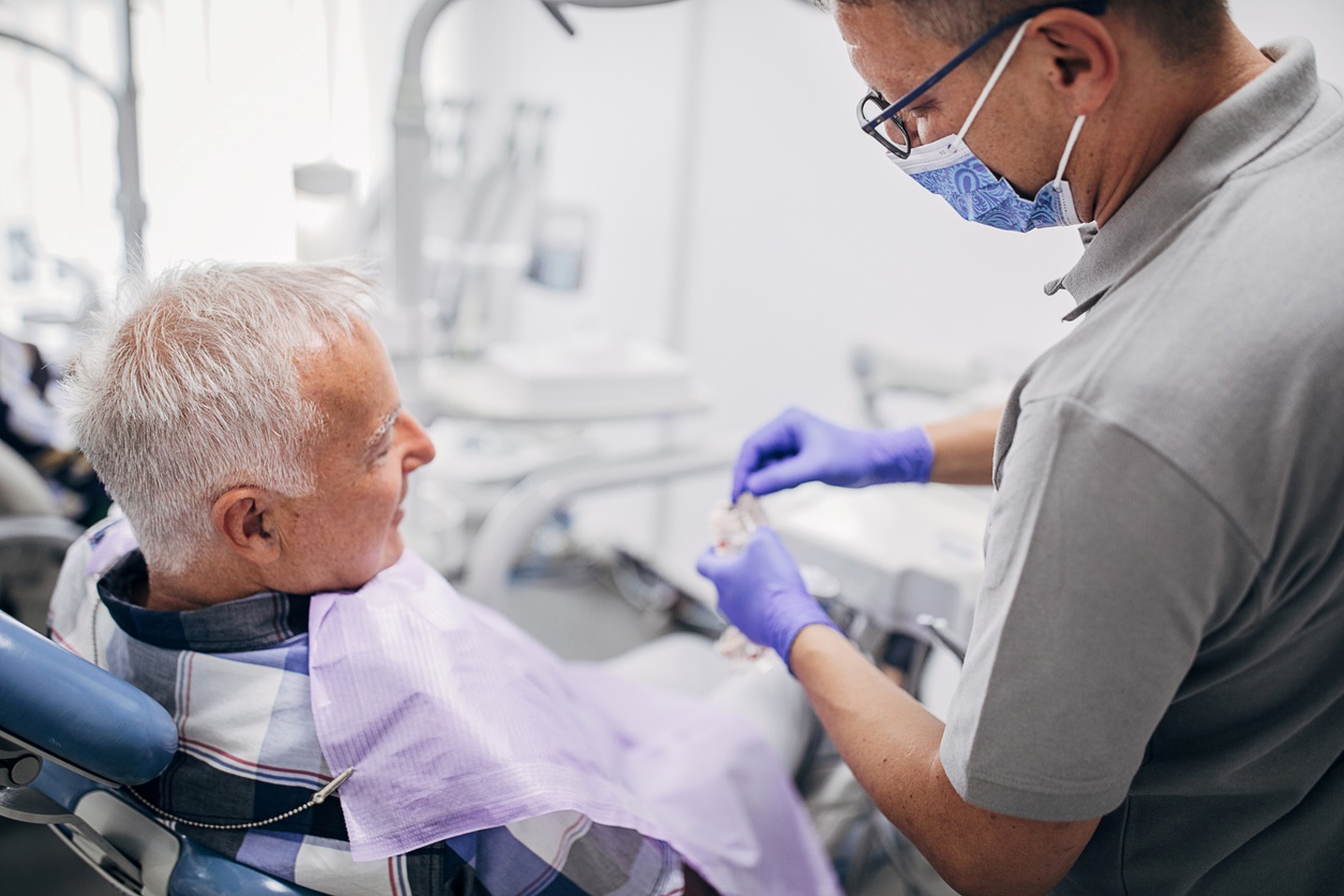 Senior patient receiving dental examination from our dental professional in clinic treatment room