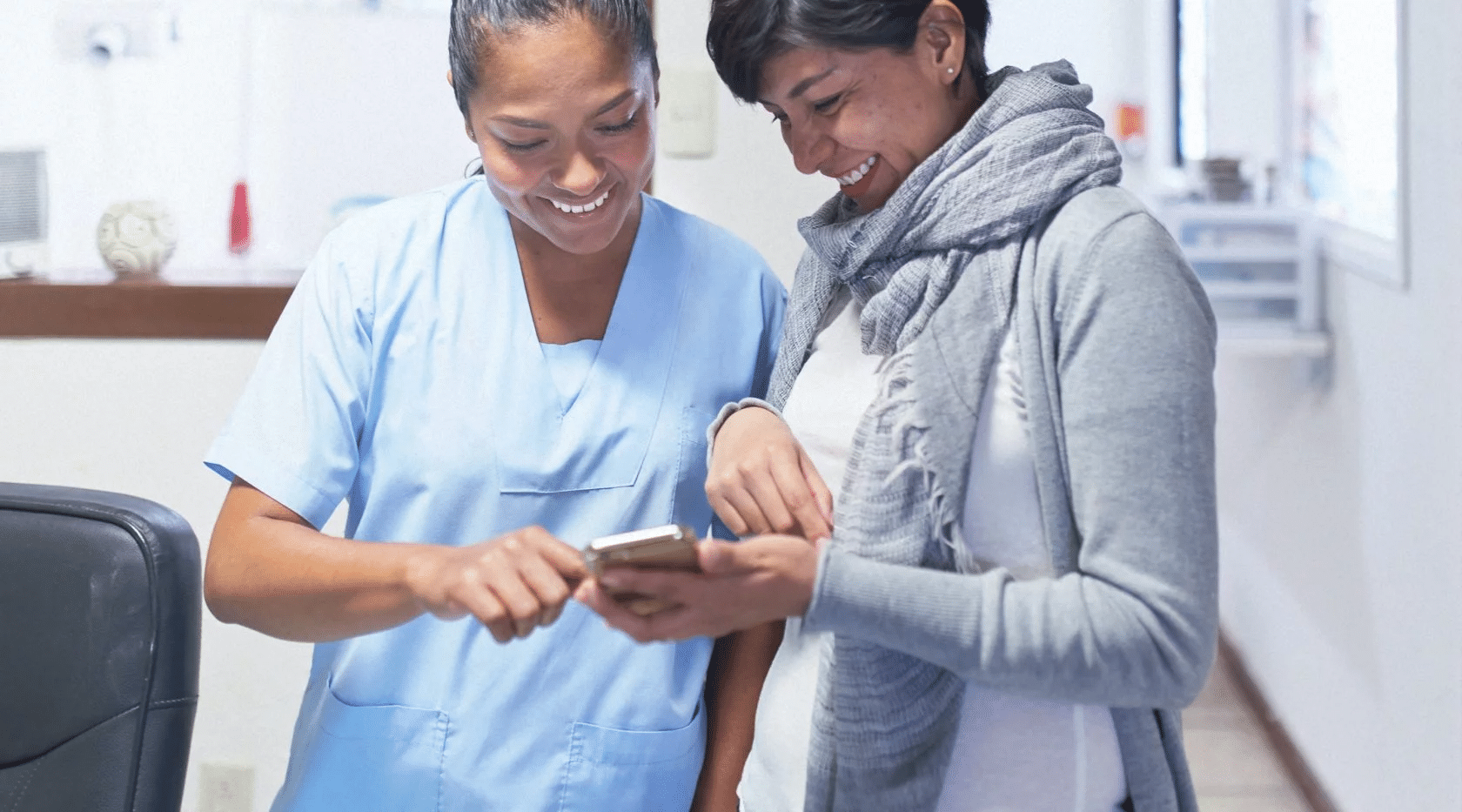 Pregnant patient reviewing dental records with one of our dental professionals