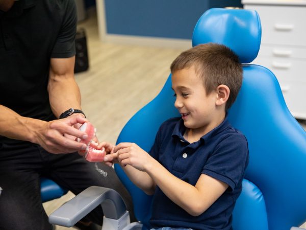 Boy receiving dental care from one of our dental professionals in treatment chair