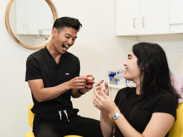 One of our dental professionals demonstrating a smile model to a patient
