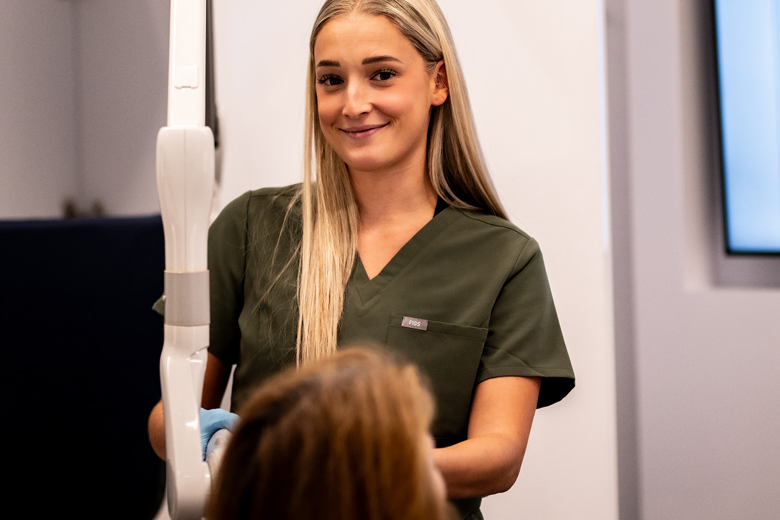 One of our dental professionals using an intraoral scanner during patient consultation