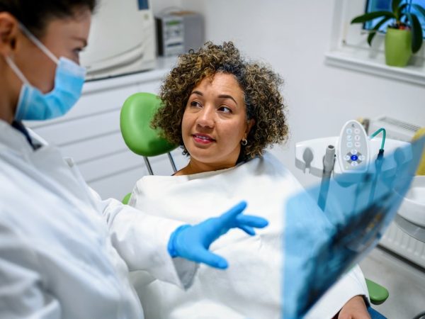 One of our dental professionals consulting with a patient in our dental clinic treatment room