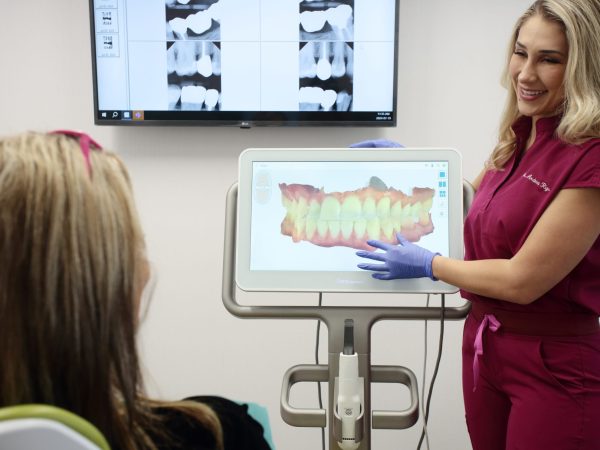 One of our dental professionals showing a 3D bite scan to a patient during consultation at our dental clinic