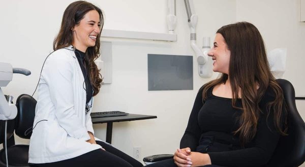 One of our dental professionals consulting with patient in treatment room