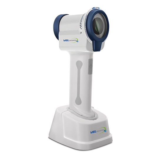 VEL Technologies dental imaging scanner with blue accents and white stand base